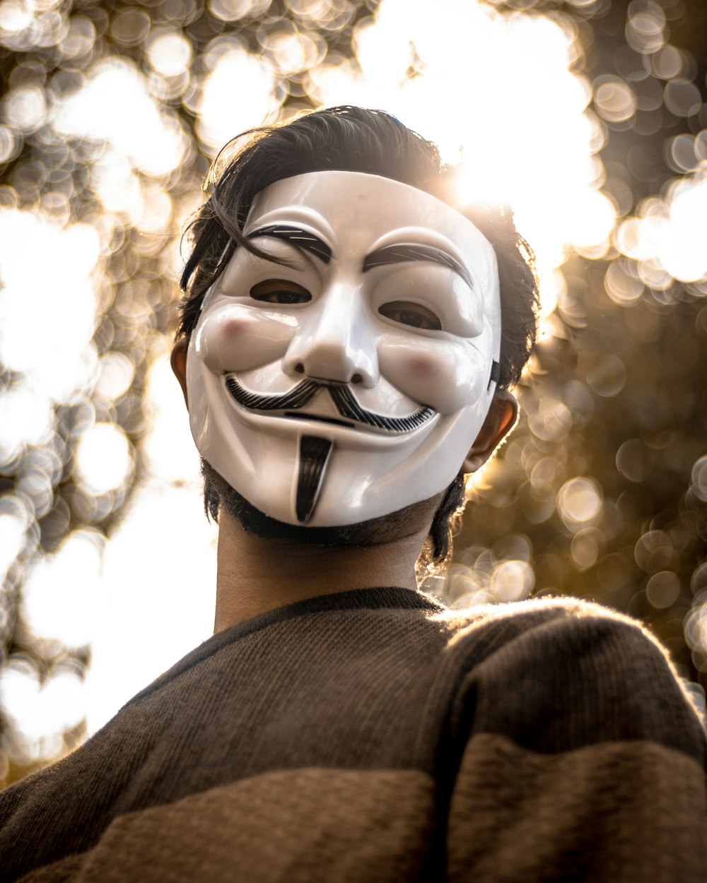 man wearing guy fawkes mask