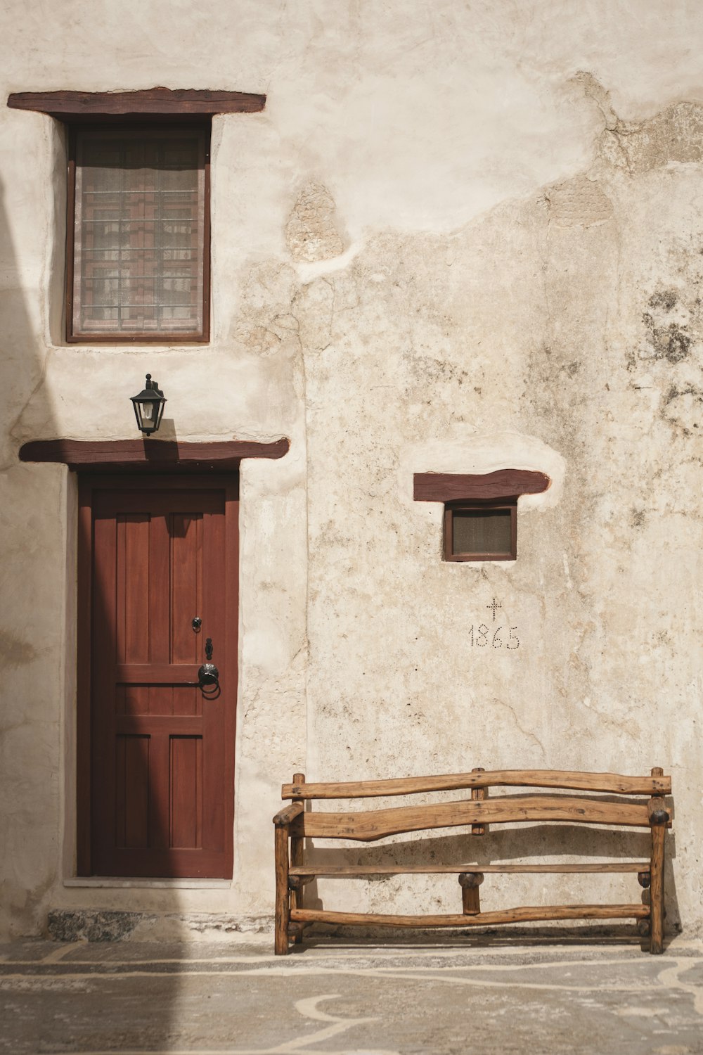 brown wooden bench near closed door