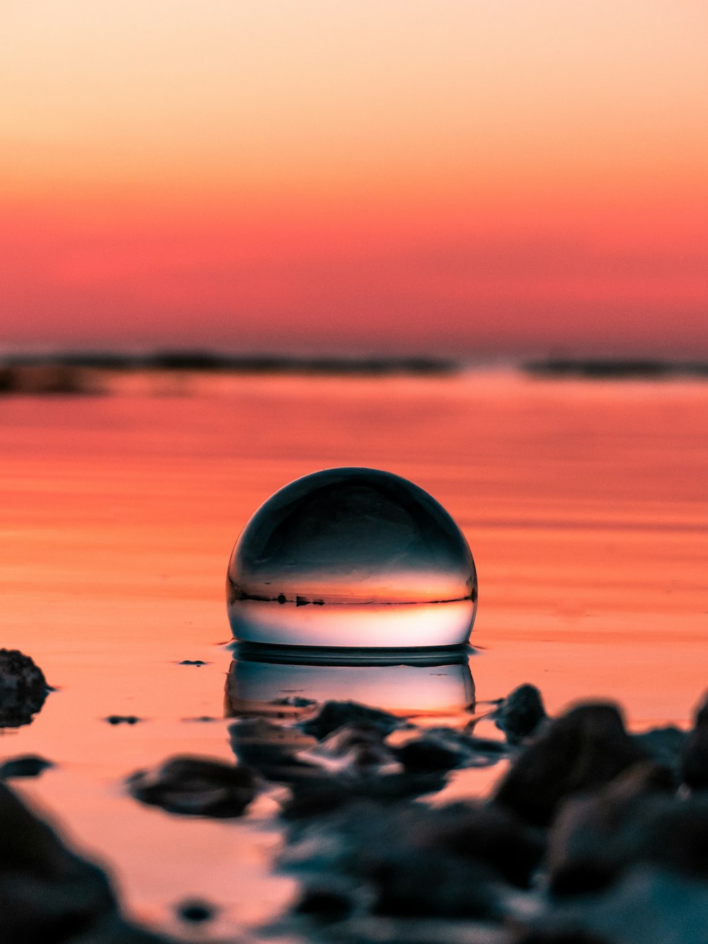 clear glass ball on seashore