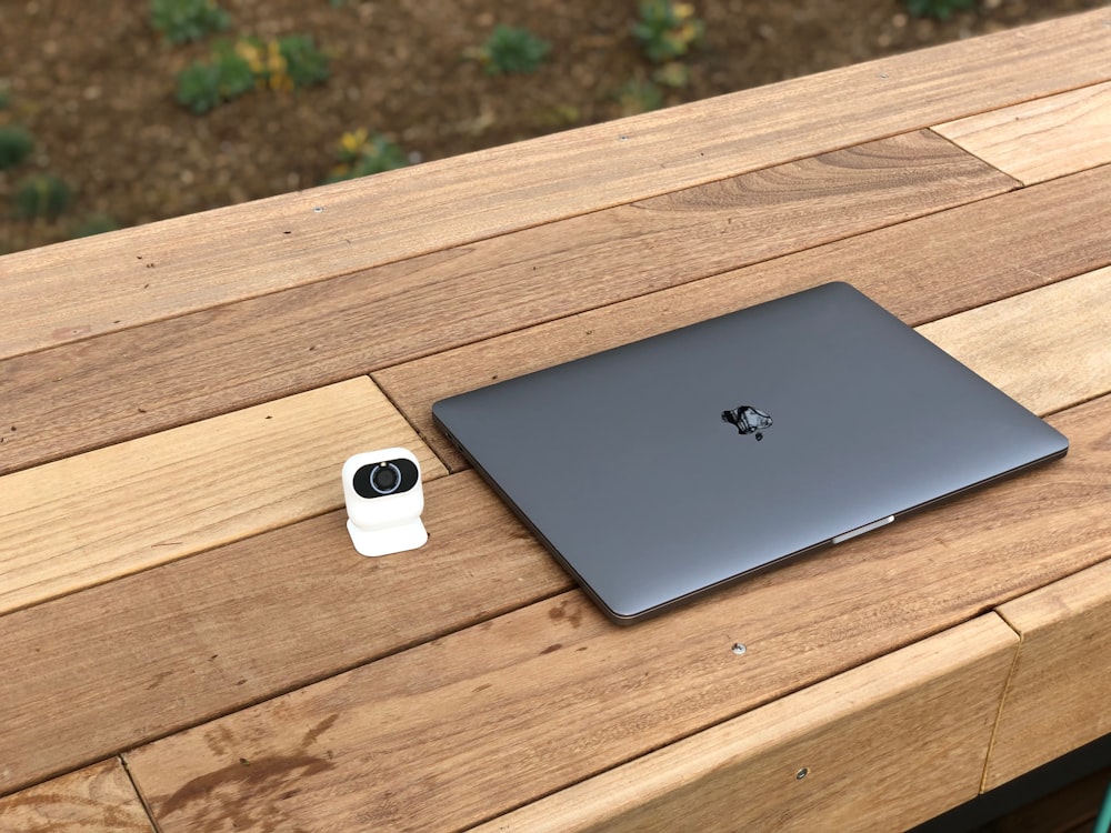 MacBook noir sur banc marron