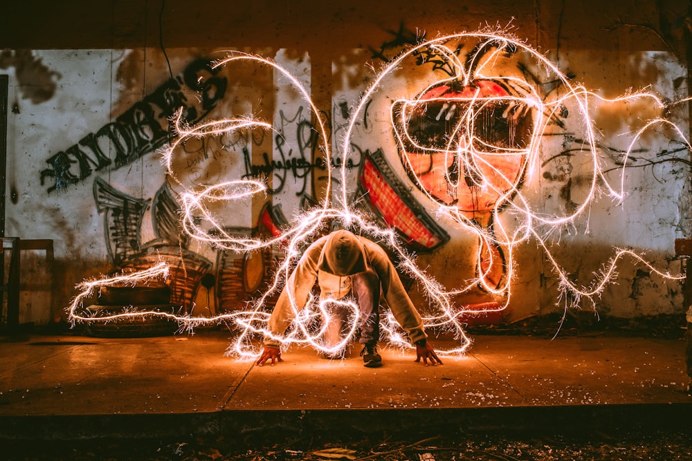 steel wool photography of man squatting