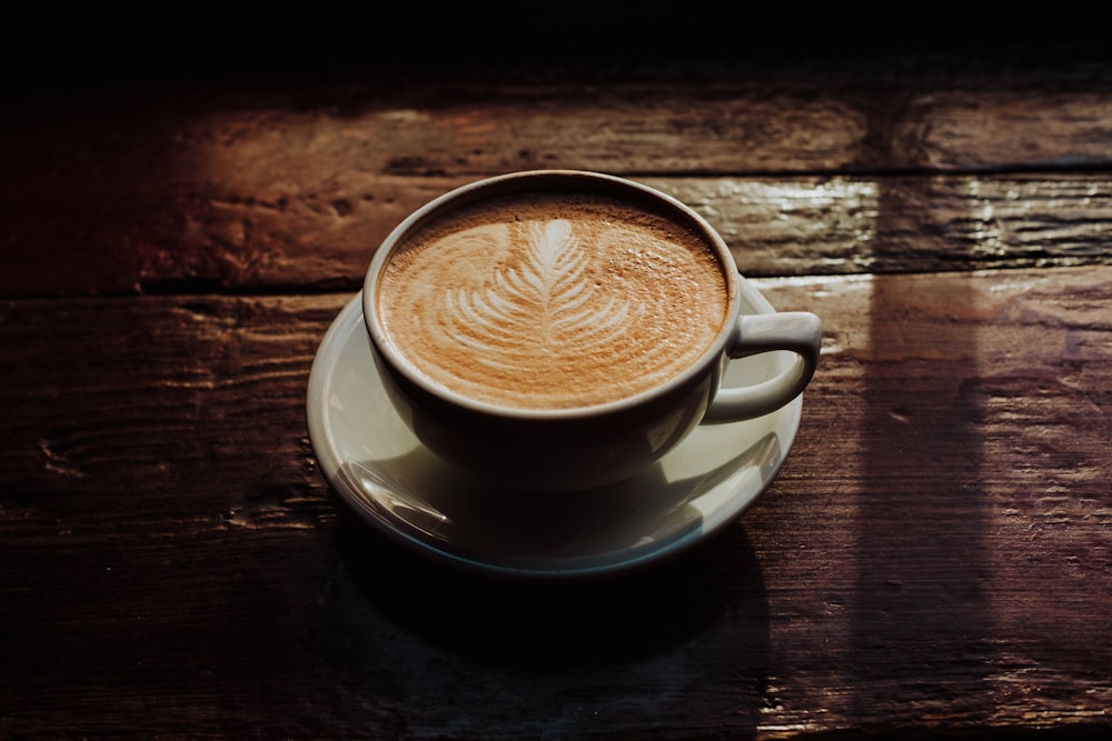 white teacup with saucer