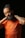 A bearded man with curly hair is holding his hands behind his neck. He is wearing an orange t-shirt with the quote 'I Sell Digital Dope' printed on it, along with a tag '@shotbysham.' The background is solid black, creating a stark contrast with the subject's attire. The man's expression appears relaxed and casual.