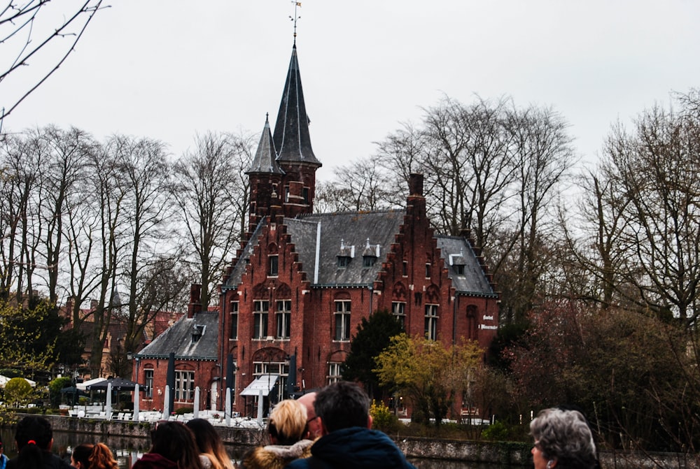 people standing near brown building