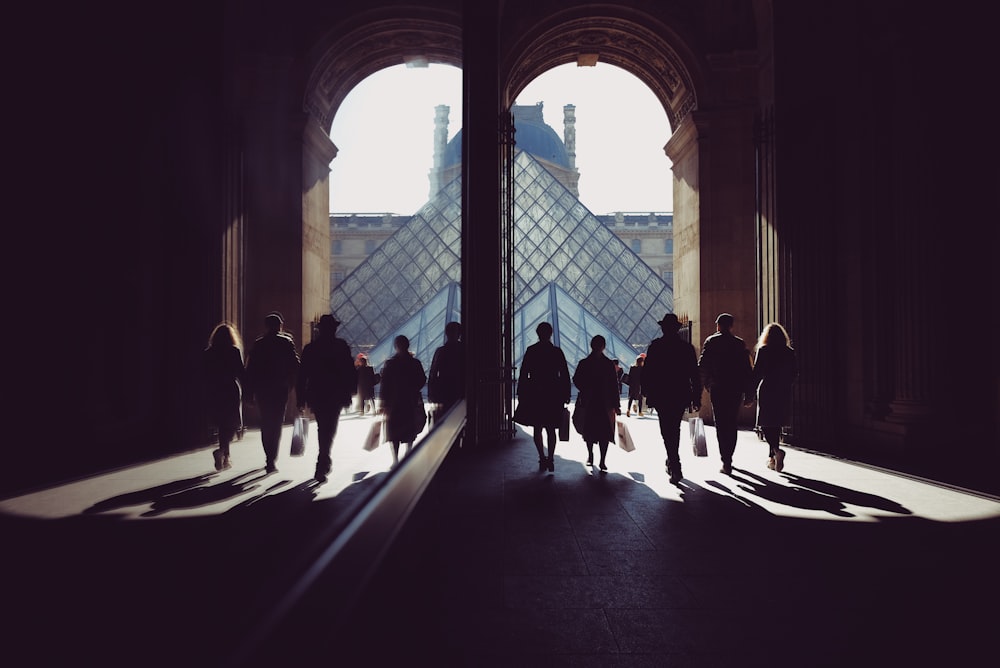 group of people standing inside brown building