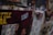A collection of layered posters and advertisements, including partially visible text with the word 'STIIIZY' prominently displayed in blue. The images on the posters feature various people and abstract designs, with some sections obscured or overlapping. The overall scene is busy and textured, conveying a sense of urban culture.