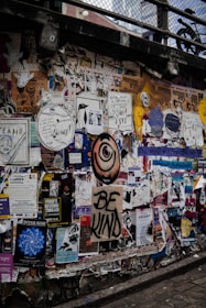 Photographs displayed on a vibrant urban wall, showing diverse community life.