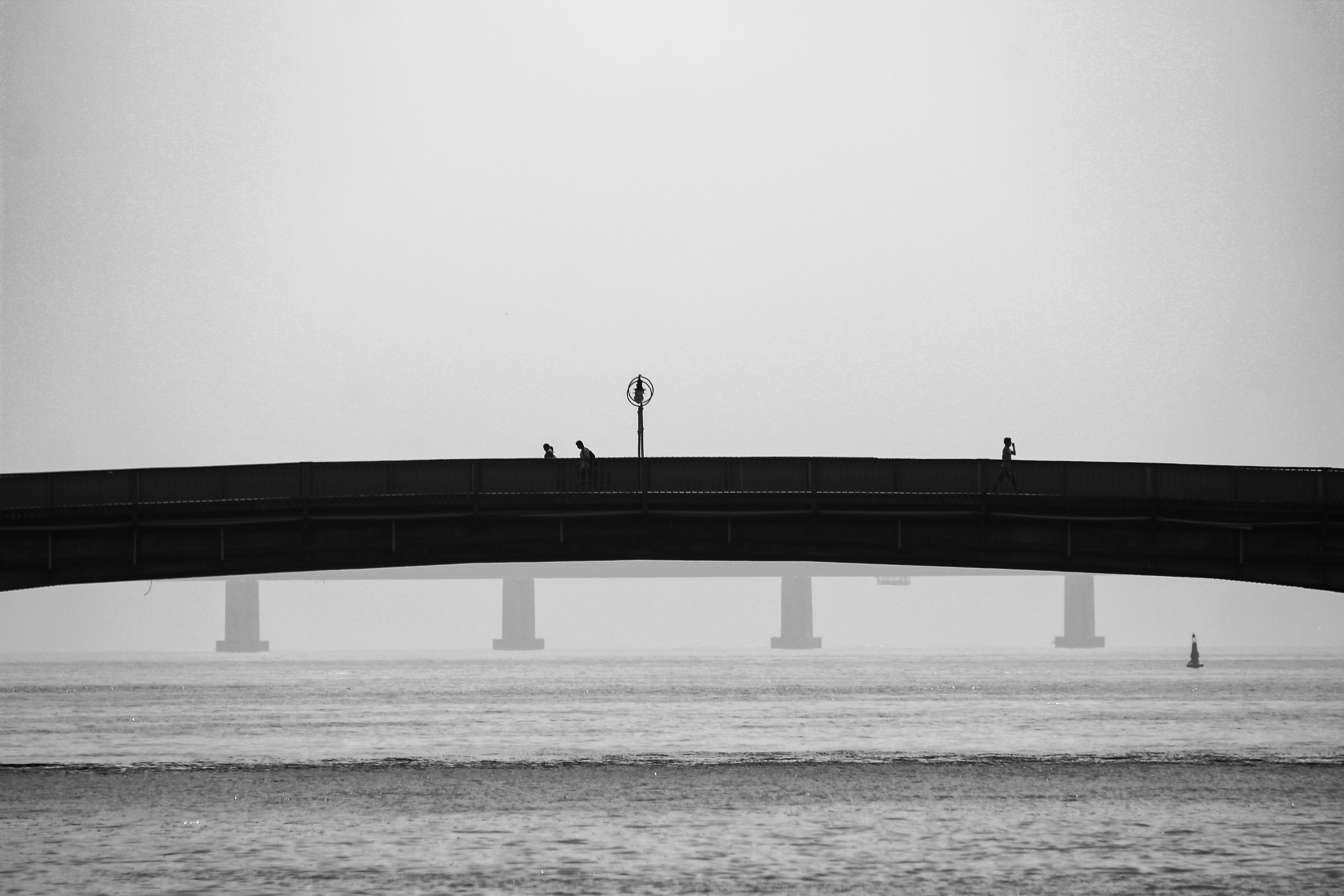 bridge over calm sea during daytime