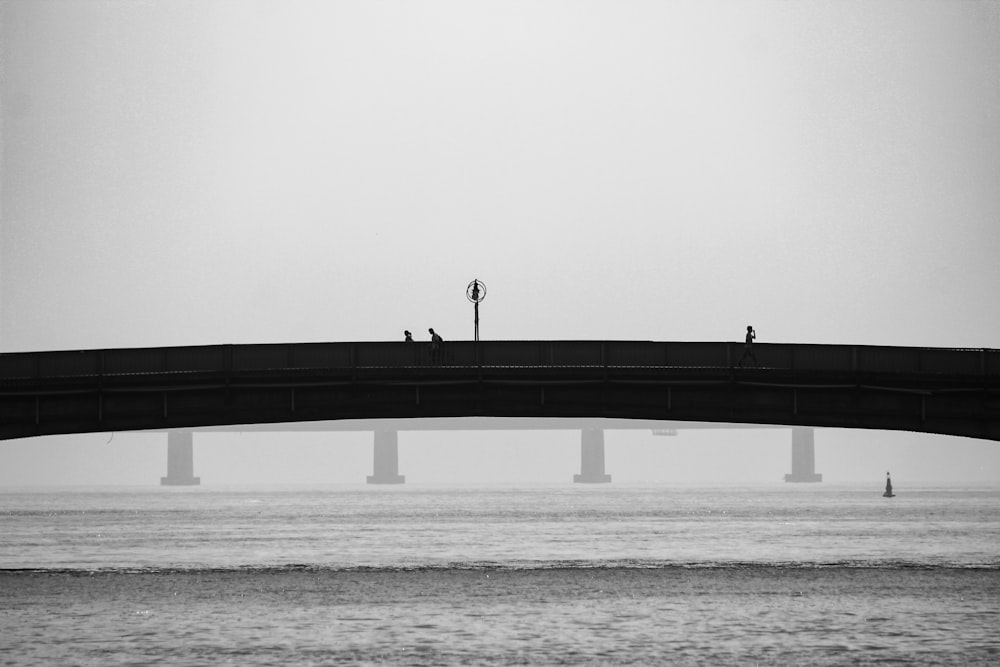 bridge over calm sea during daytime