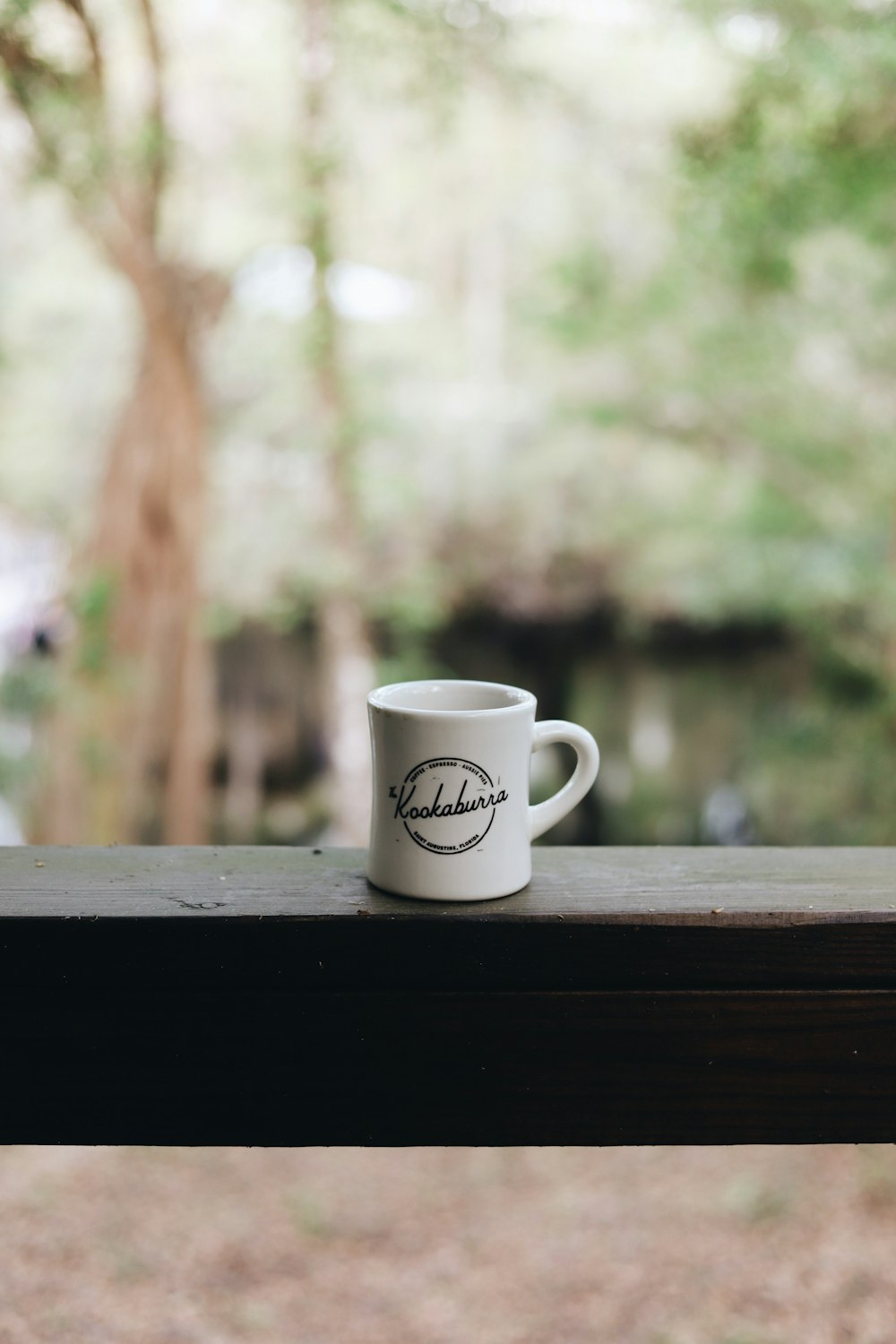 white and brown ceramic mug