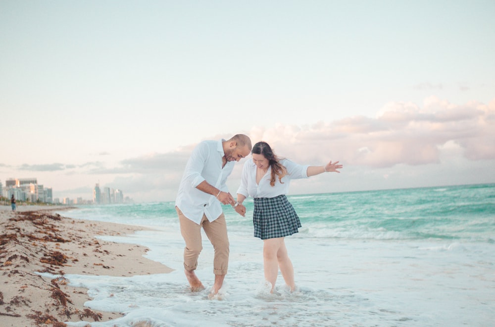 man and woman stepping on ocean