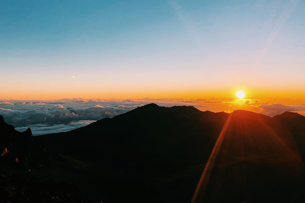 silhouette of mountain during golden hour