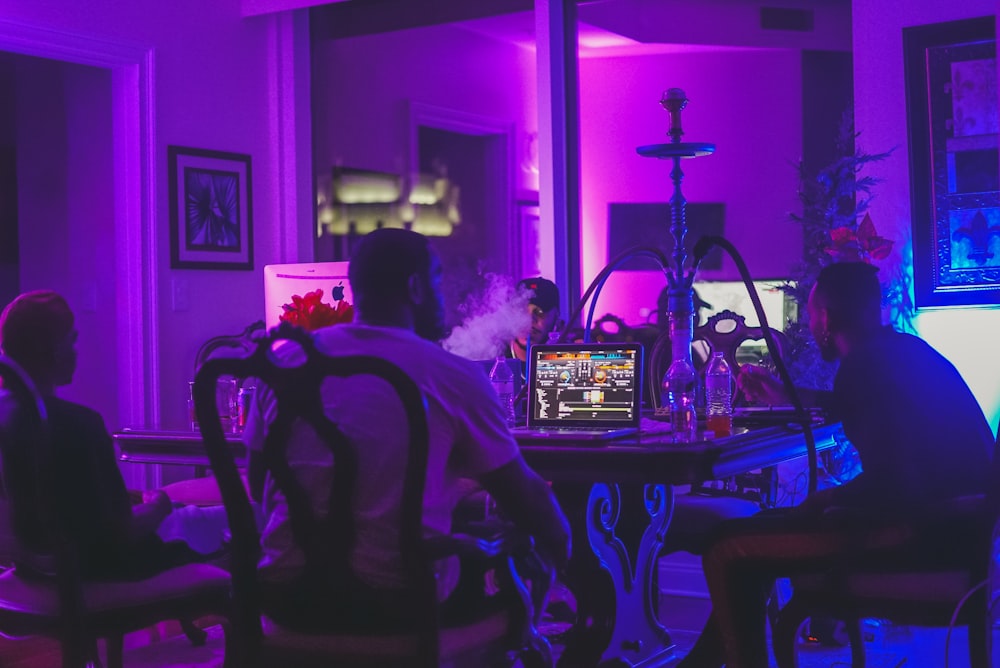 people sitting on chair with hookah on top of table