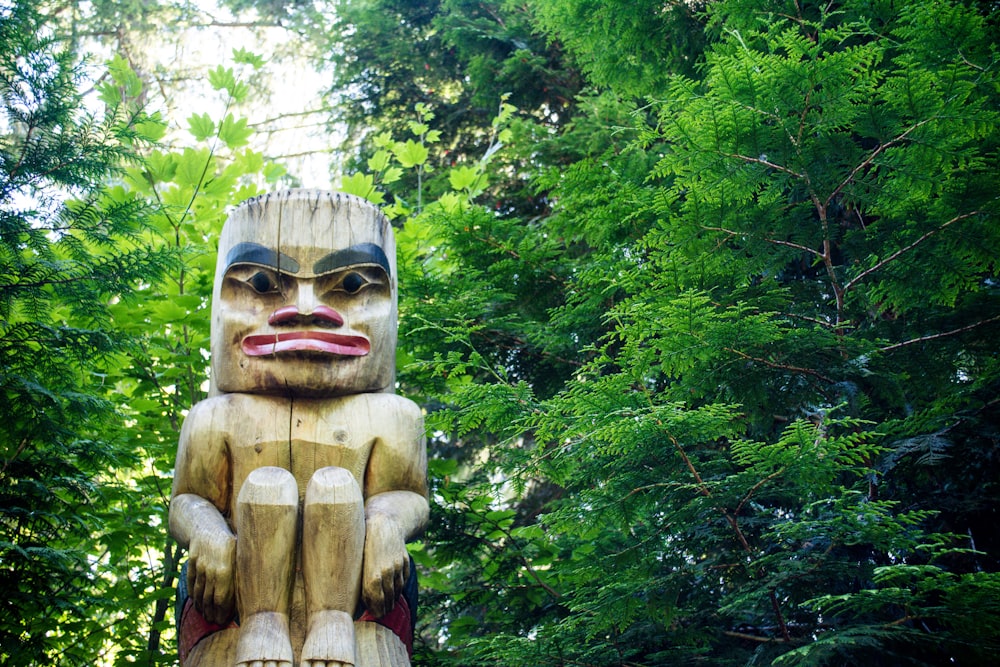Tiki statue surrounded by green trees