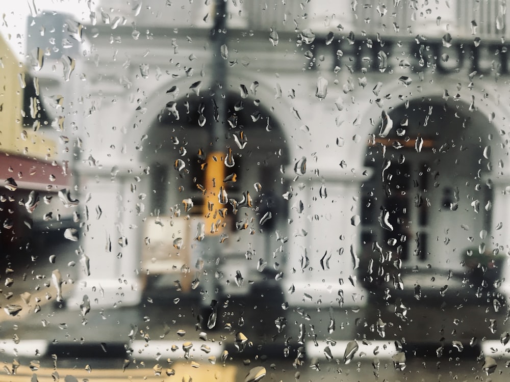 selective focus photography of water drops in window