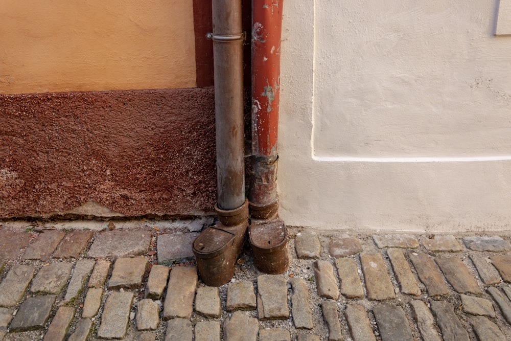 Dos tubos marrones al lado de la pared