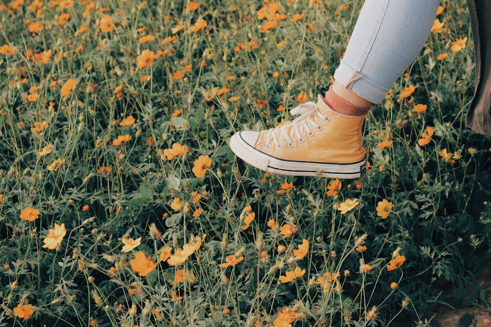 yellow and white lace-up sneaker on foot