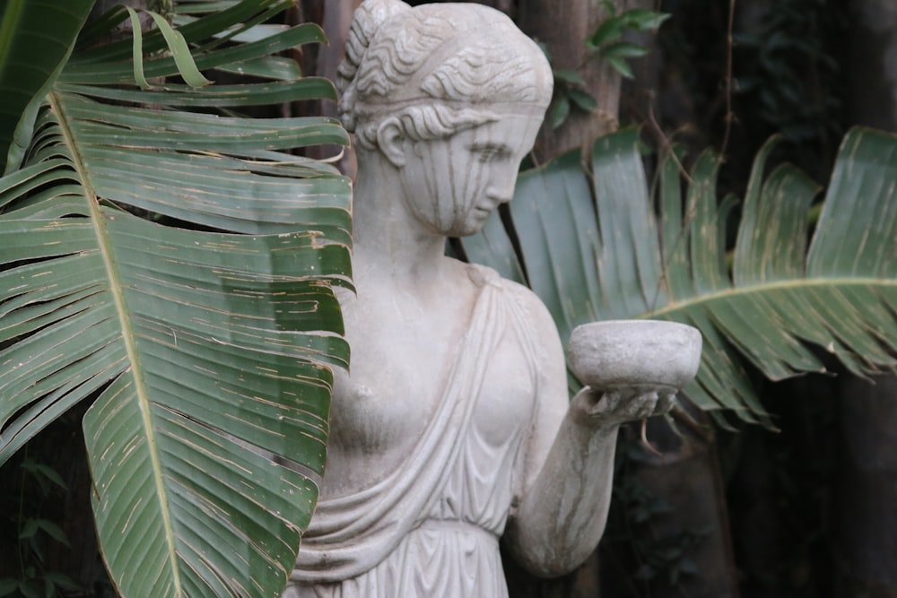 woman holding bowl statue