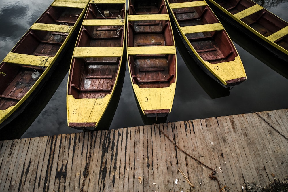 five brown-and-beige boats near dock