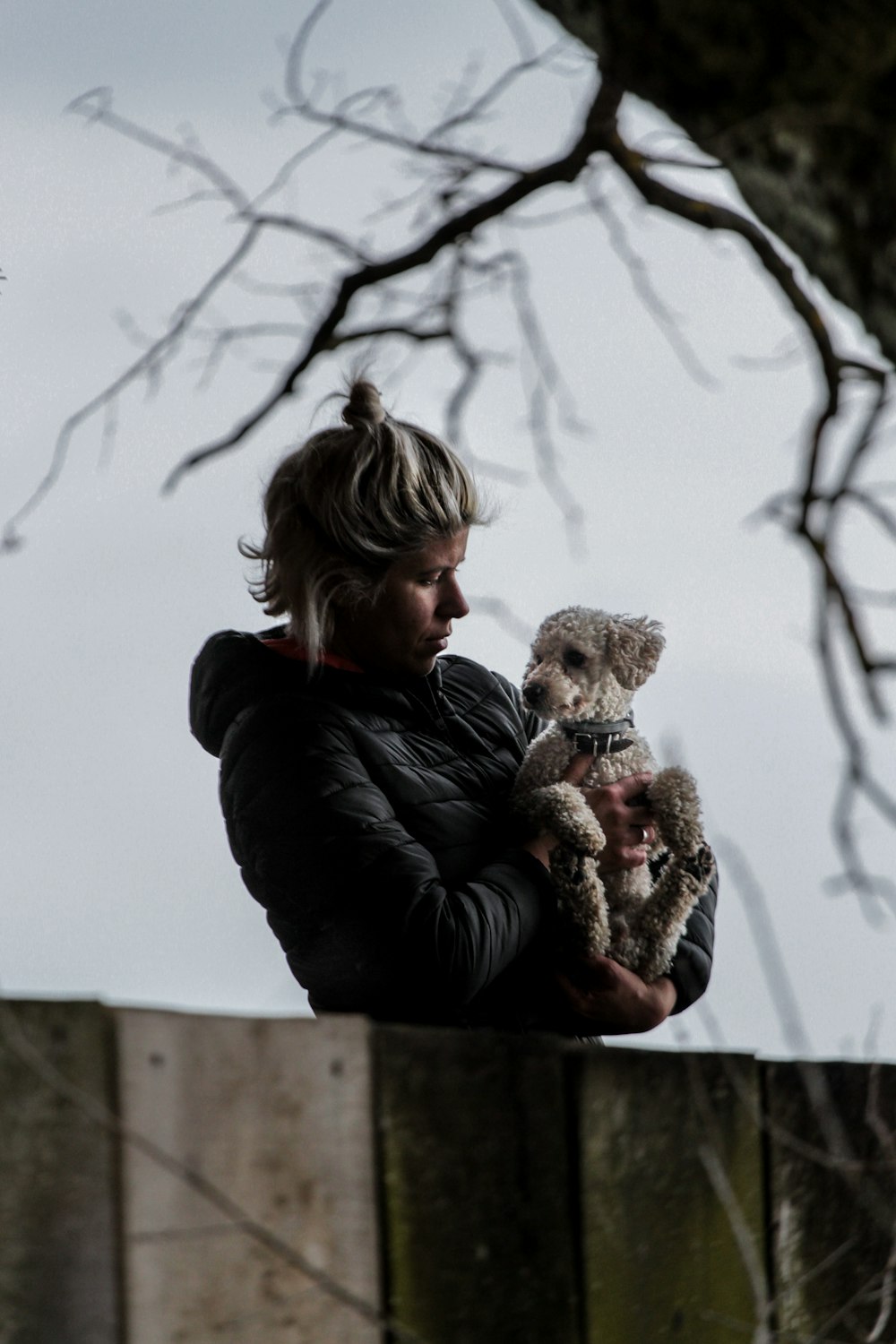 man carrying dog