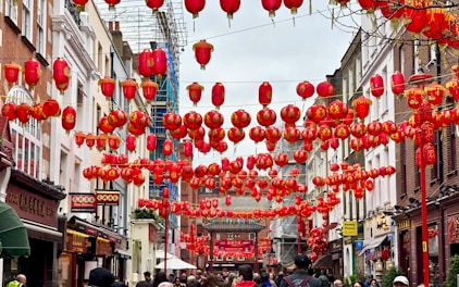 people walking under red lanterns