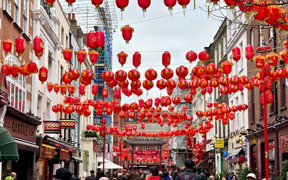 people walking under red lanterns