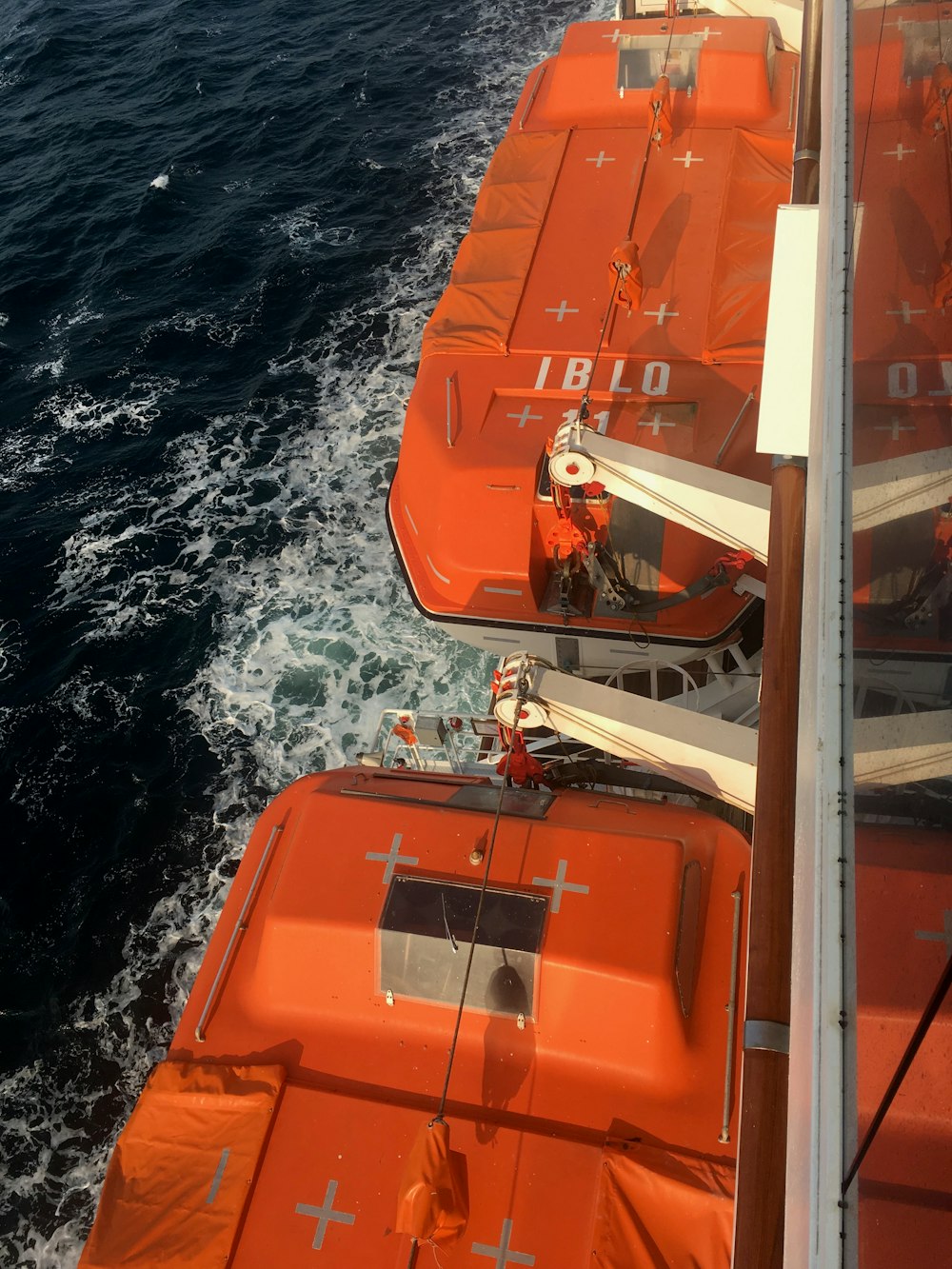 orange boat on ocean