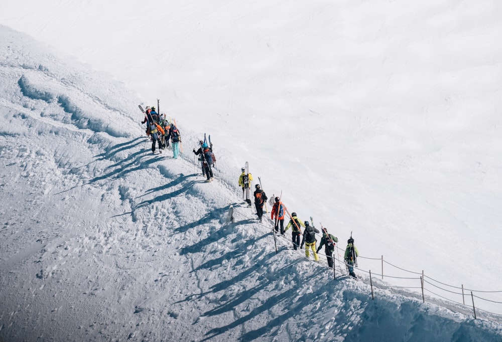 group of person walking on snow covered area