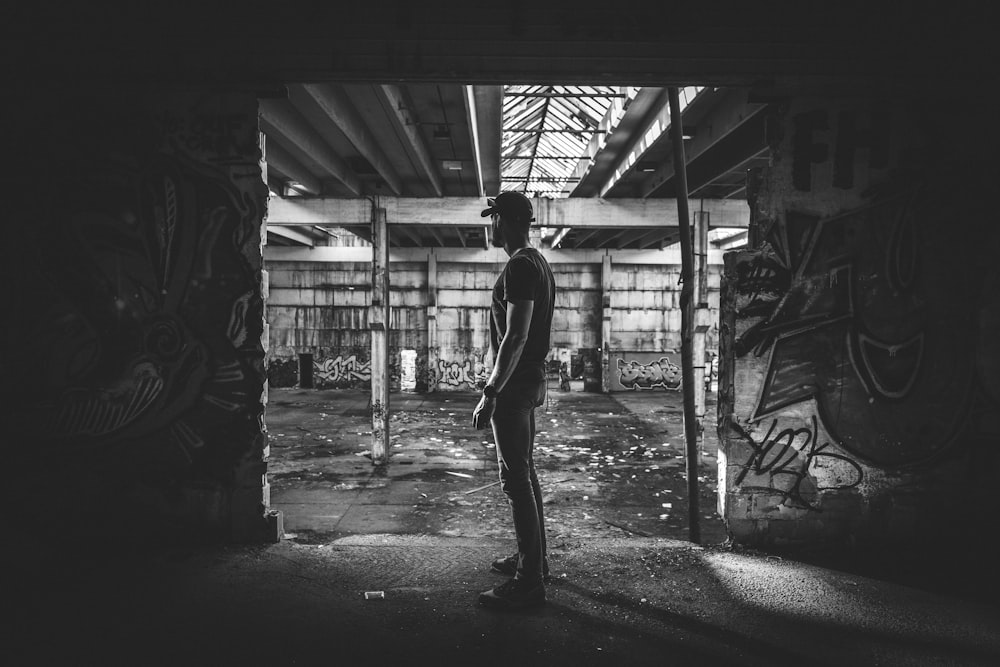 grayscale photography of man in building