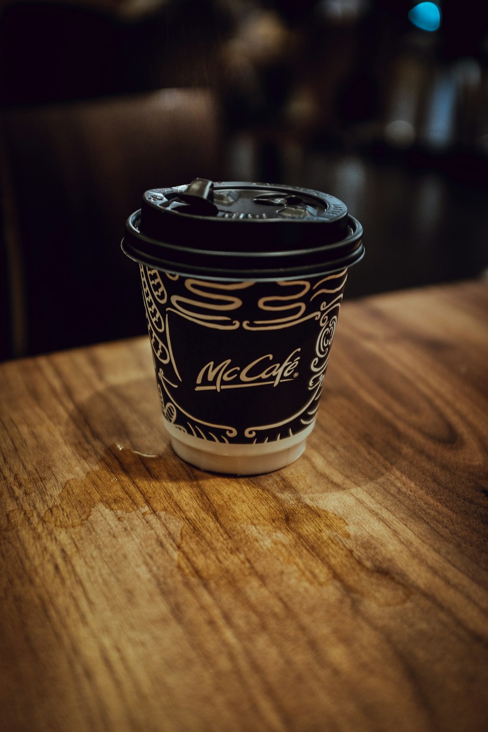 black and white disposable cup on table