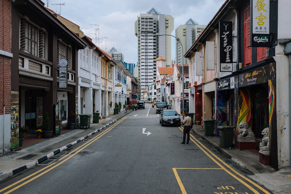 wide road with buildings under cloudy sky