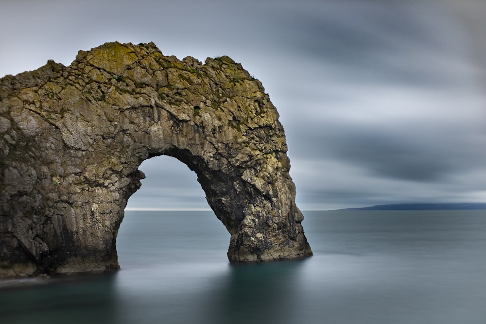 gray rock formation on body of water