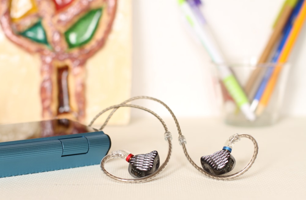 black-and-gray earbuds on selective focus photography