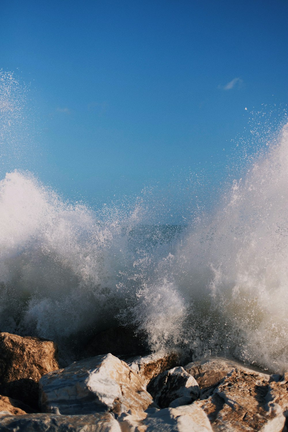 ocean waves crashing on rock formation