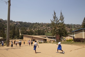 A group of prospective students and parents walking through the school grounds on a sunny day