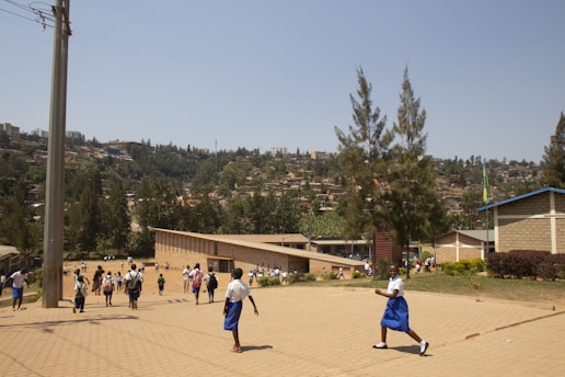 A group of prospective students and parents walking through the school grounds on a sunny day