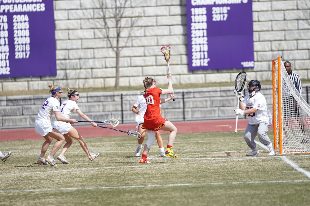 women playing lacrosse at the field