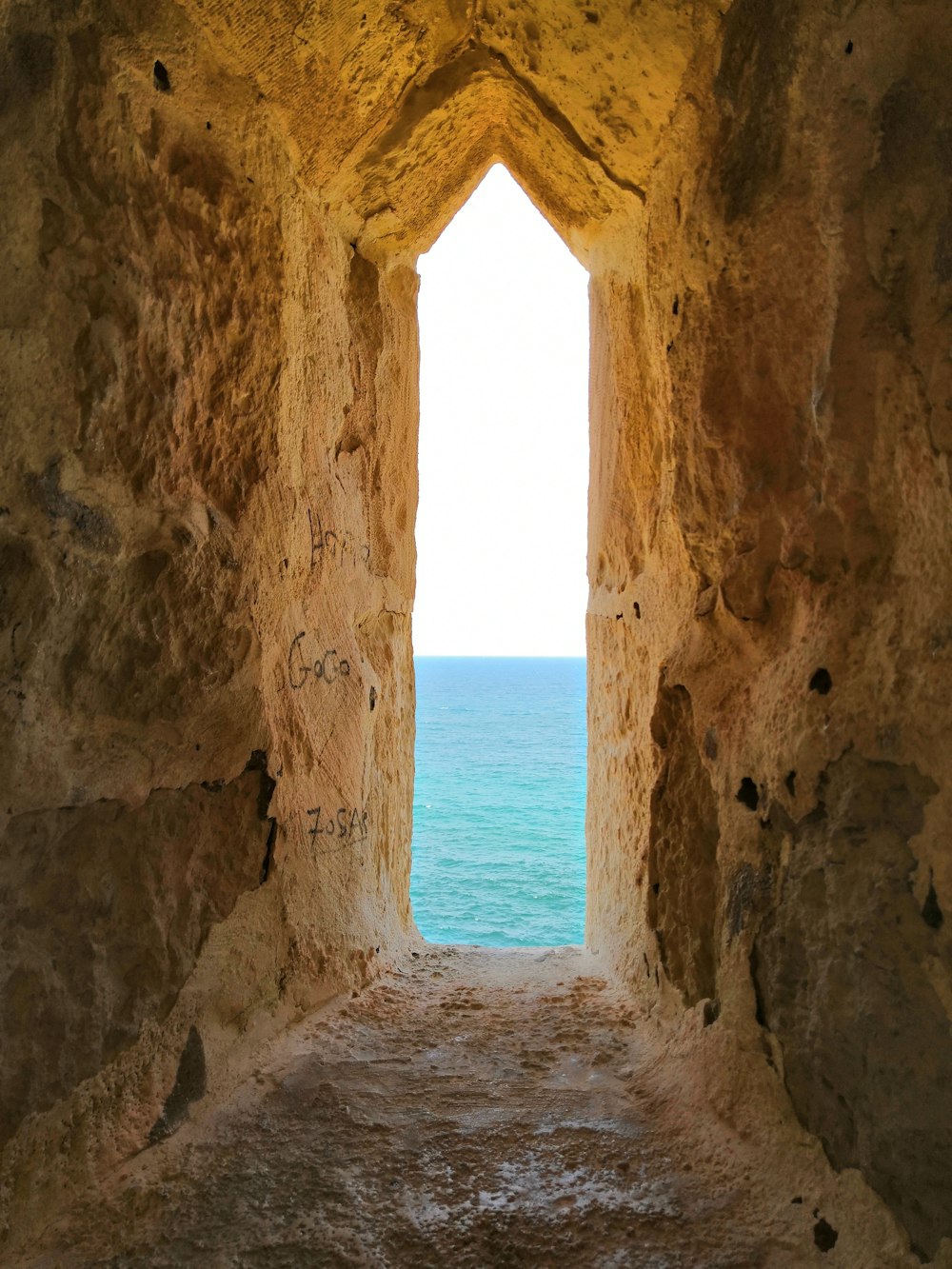 concrete arch near body of water