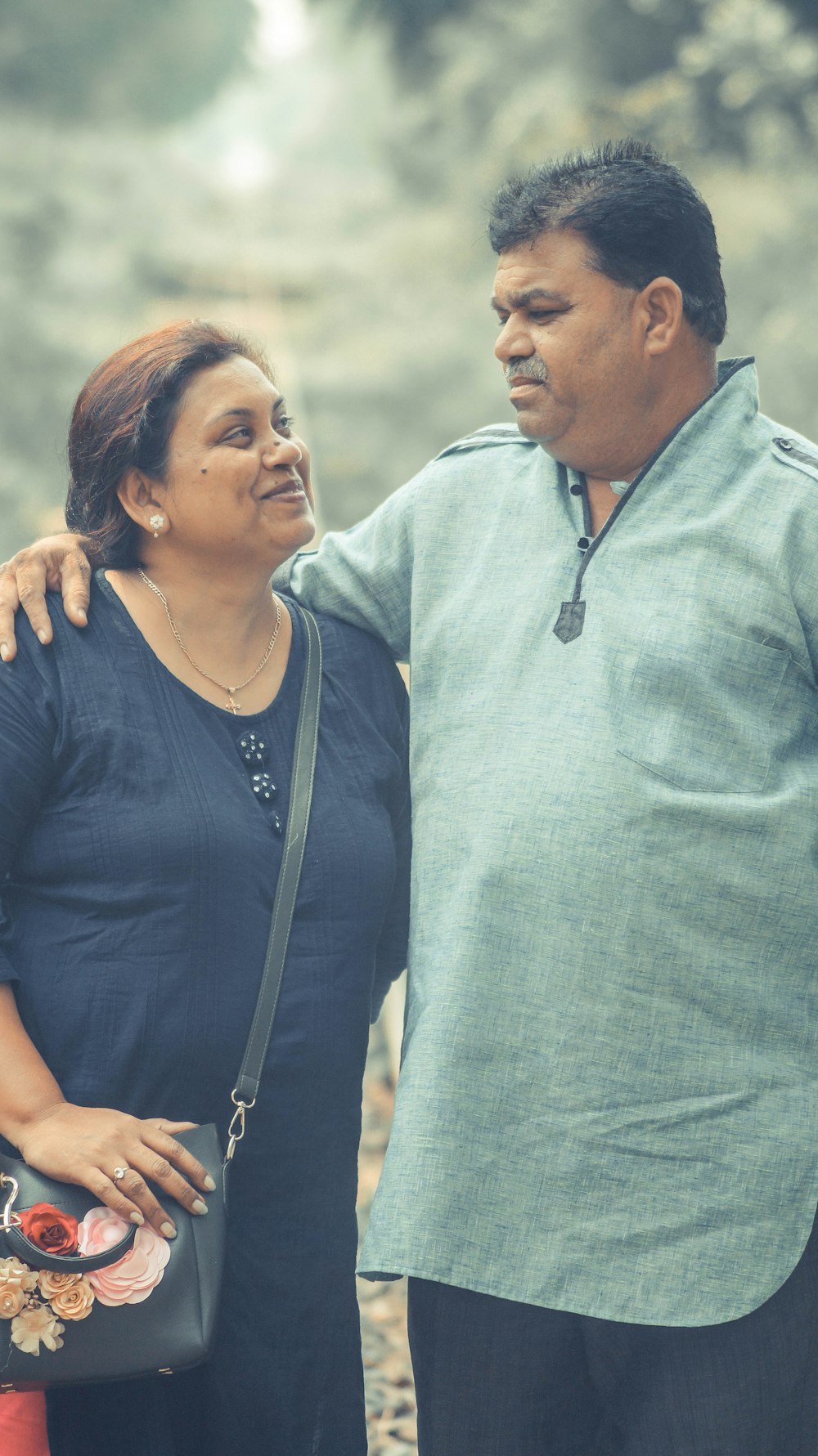 man with hand on women's shoulder