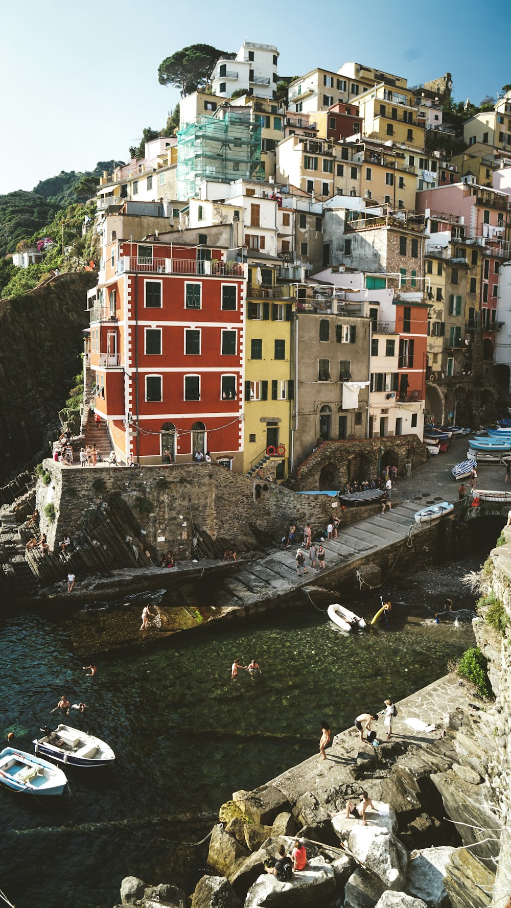 multicolored concrete building on mountain near river