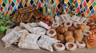 Guests happily enjoying a variety of pastries and desserts at a casual celebration.