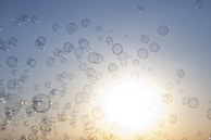 Bubbles floating in the air above freshly laundered clothes.