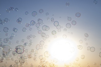 Bubbles floating in the air above freshly laundered clothes.