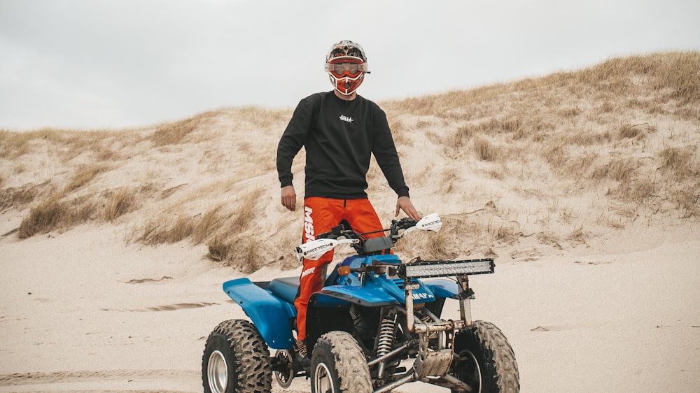 man riding blue ATV during daytim