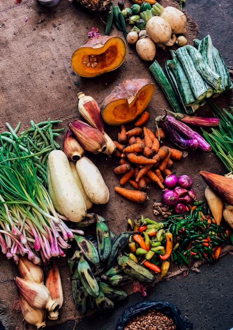 assorted vegetables on brown textile