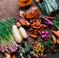 assorted vegetables on brown textile