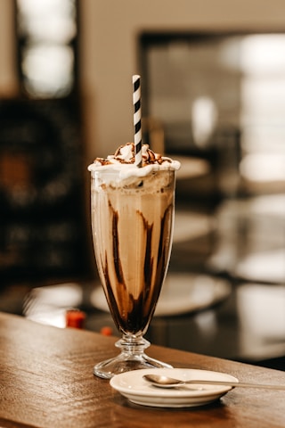 full-filled cream glass on table