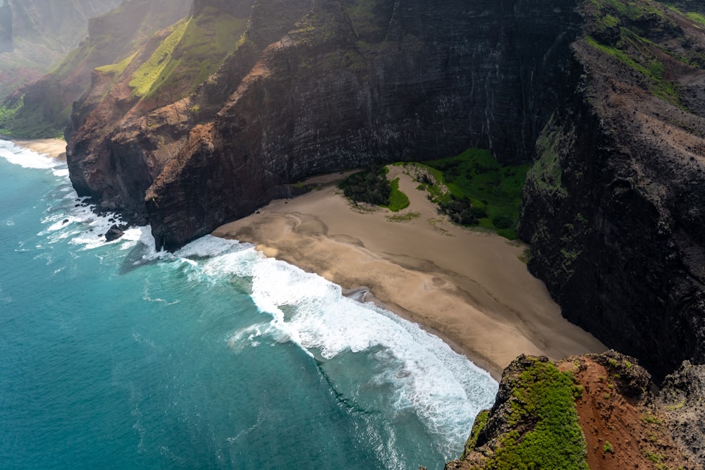 aerial photo of mountain near ocean during daytime