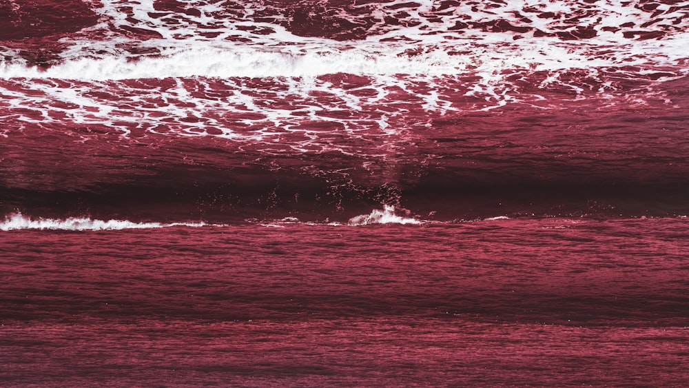 a person riding a surfboard on a wave in the ocean