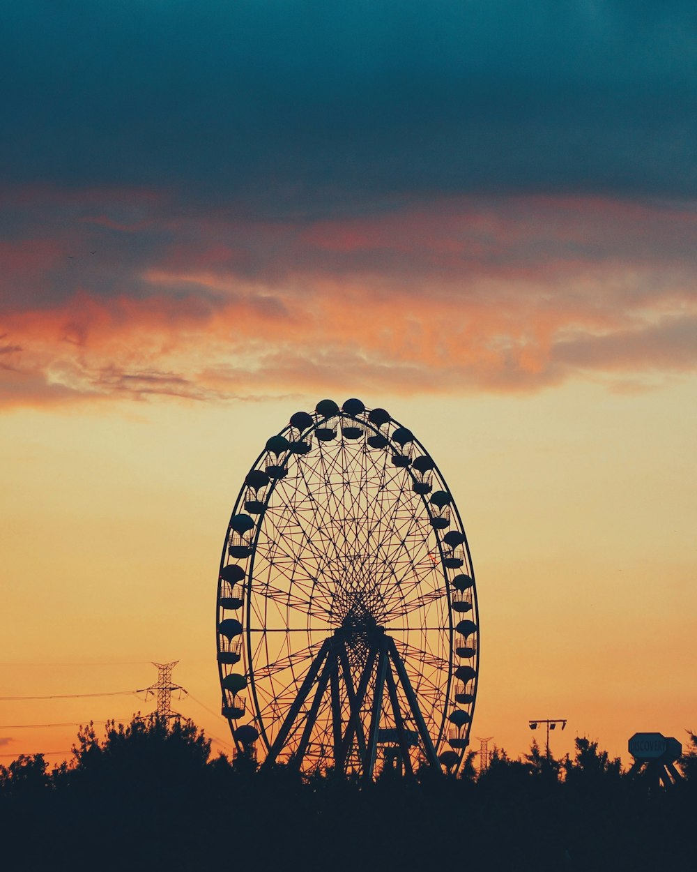 silhouette of Ferris wheel during golden hour
